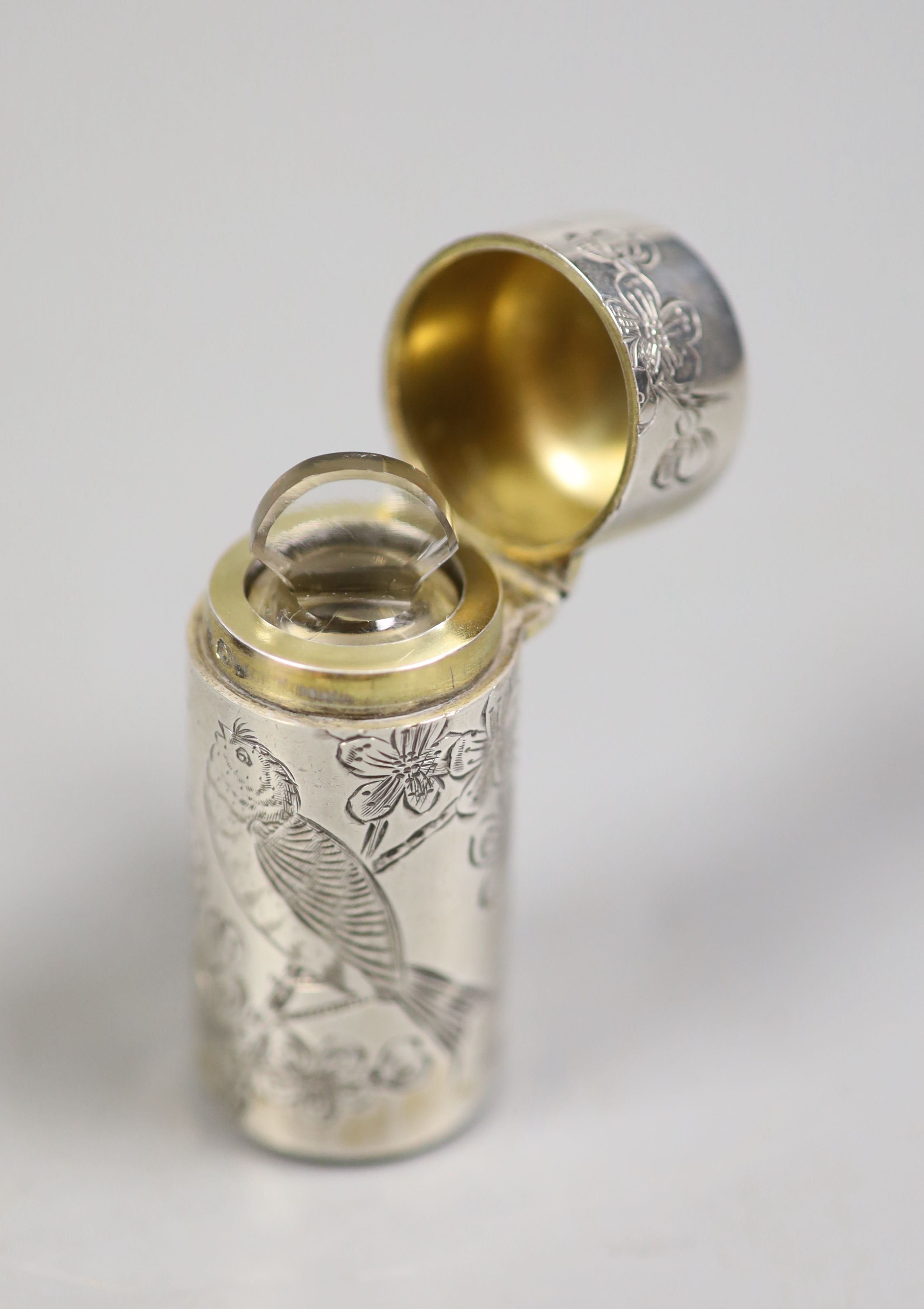 A cased late Victorian silver cylindrical scent bottle, with engraved initials and aesthetic decoration, Sampson Mordan & Co, London, 1882, 53mm.